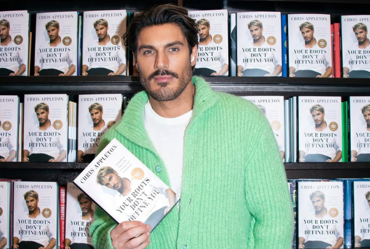 Chris Appleton holding his memoir